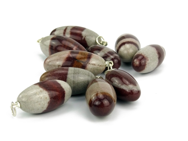 Shiva Lingam gemstone pendant selection with polished gray-red natural stone grain and bails