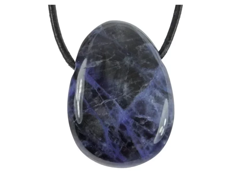 Sodalite gemstone pendant as a polished oval drilled stone with a black cord on a white background