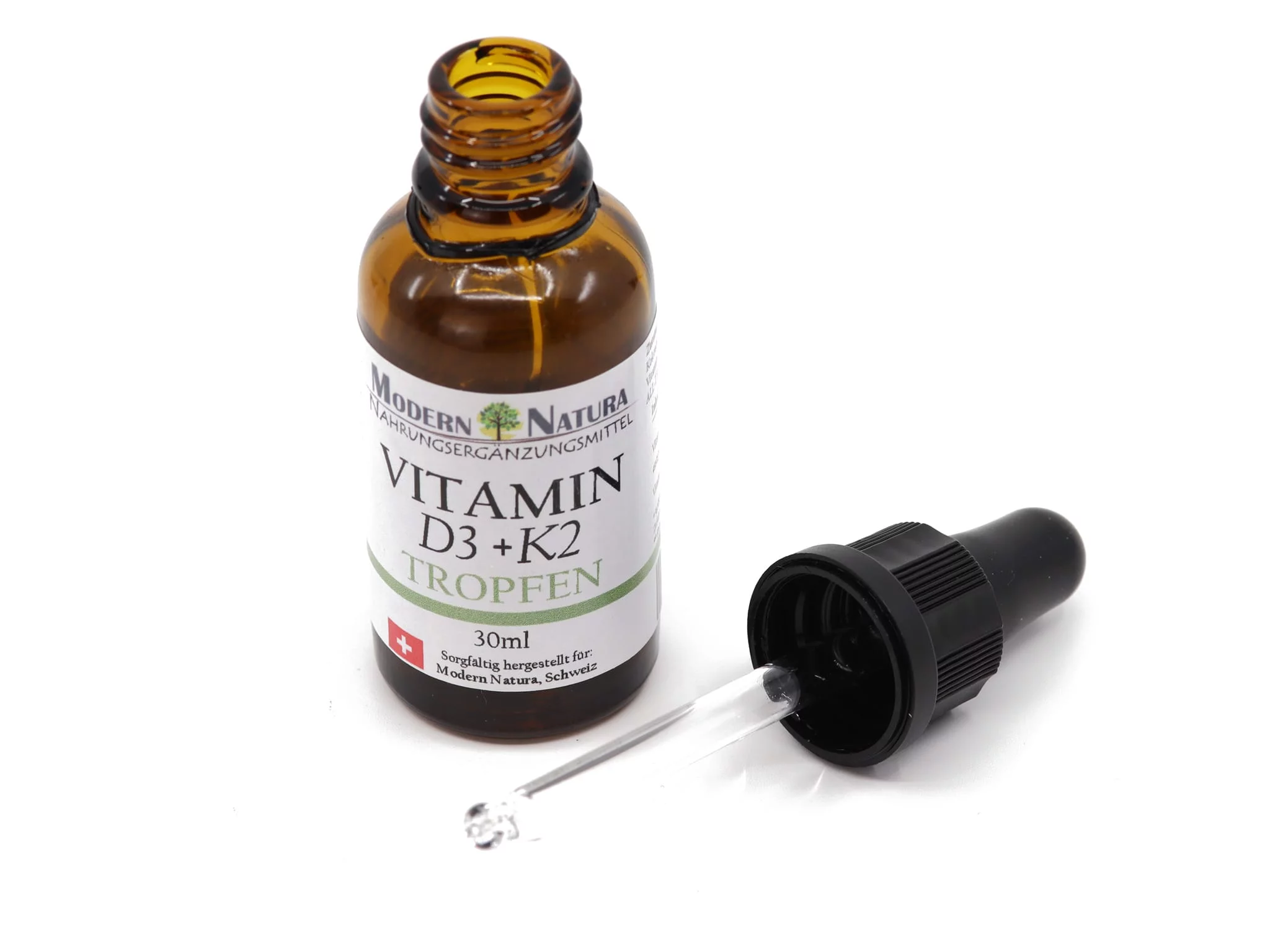 Vitamin D3 + K2 Drops with open 30 ml amber glass bottle and lying pipette