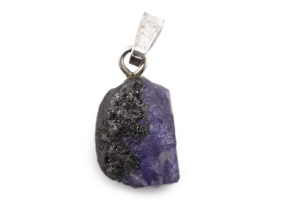 Close-up of a raw tanzanite pendant with violet and dark natural texture