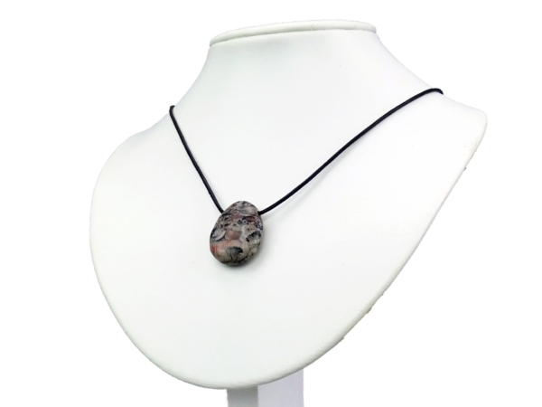 Trochit gemstone pendant as a necklace view on a white jewelry bust